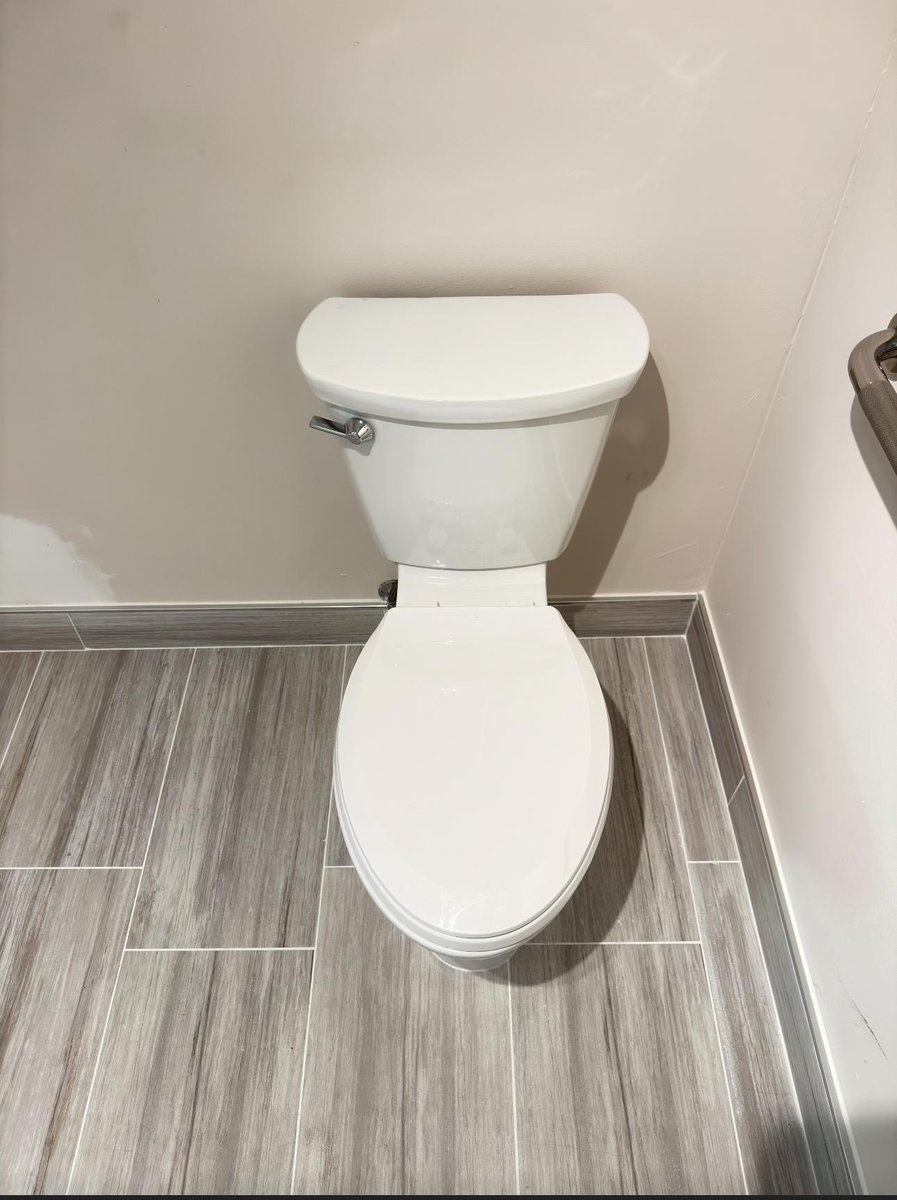 Modern vessel sink installed on dark marble countertop