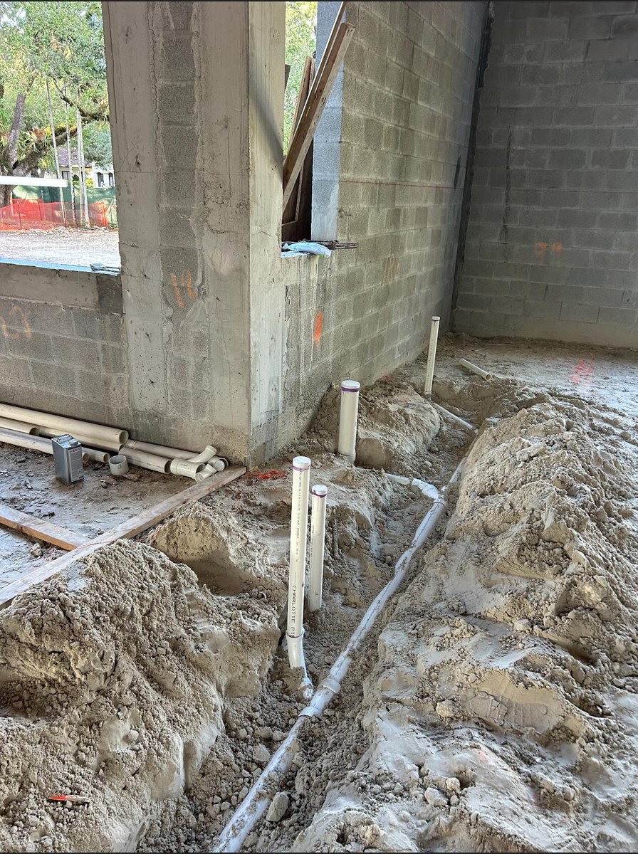 Gold shower panel with multiple controls mounted on wall