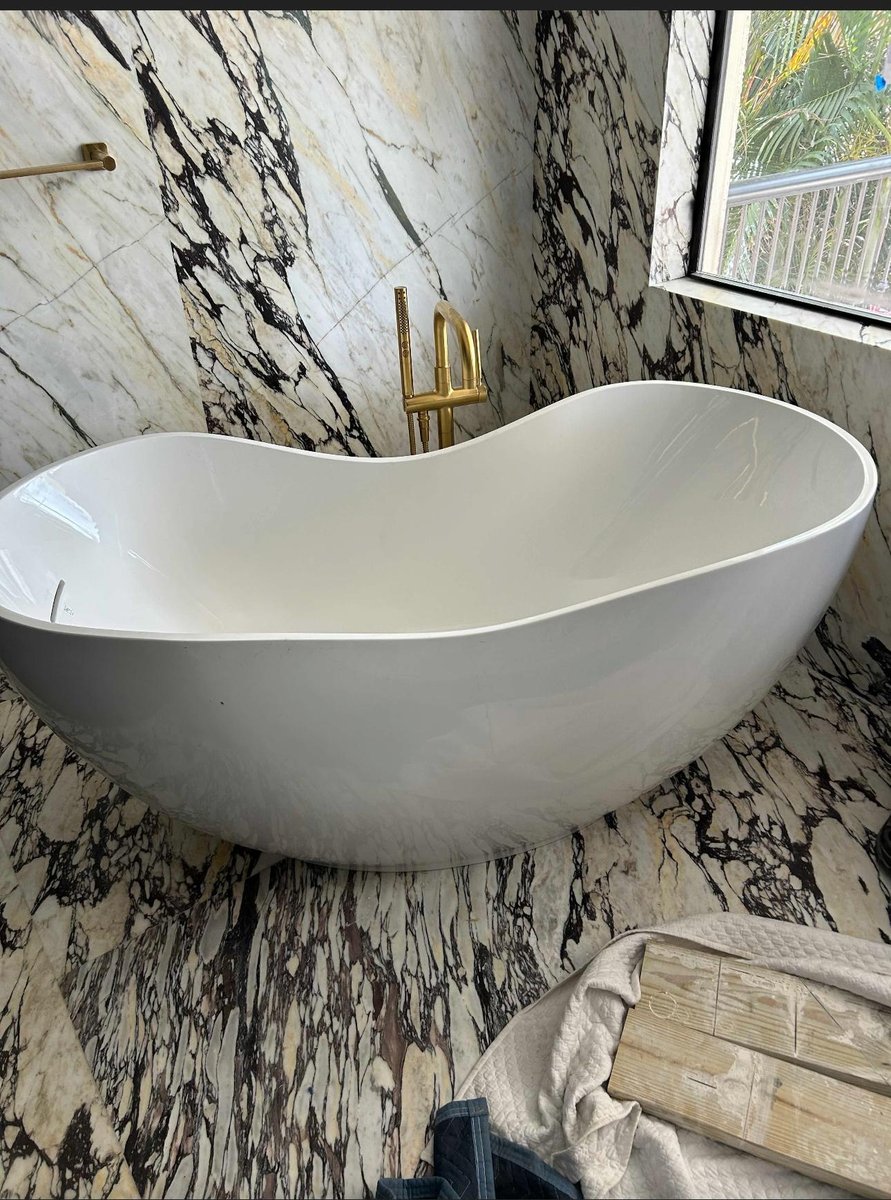 Modern toilet installed in marble bathroom